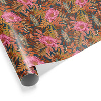 Rolled gift wrap featuring pink peonies and orange foliage on a dark teal background. Illustrated by Lisel Ashlock.