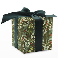 A wrapped gift box with olive green snowbell flower pattern and a dark teal ribbon bow. Illustrated by Lisel Ashlock.