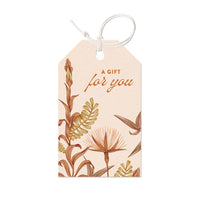 Beige gift tag with botanical illustrations and "A gift for you" text, Illustrated by Lisel Ashlock.