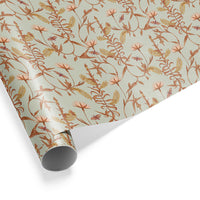 Roll of floral gift wrap featuring lily and tree branches in coral and gold on flax background. Illustrated by Lisel Ashlock.