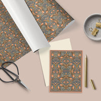 Flat lay of apricot-patterned gift wrap with coordinating thank you card, white ribbon, scissors, and brass clips on beige background. Illustrated by Lisel Ashlock.