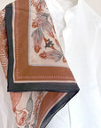 Sunstone silk cotton scarf featuring botanical illustrations of flowers and ferns in terracotta, navy, and cream tones. Illustrated by Lisel Ashlock.