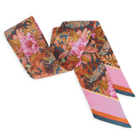 Two silk twill twilly scarves with peony florals and striped ends in pink, gold, and navy. Illustrated by Lisel Ashlock.