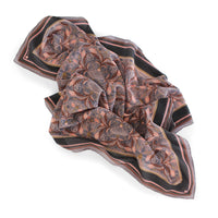 Silk cotton scarf with ornate filigree pattern in rust and lavender tones on black border. Illustrated by Lisel Ashlock.