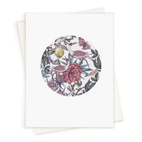Blank greeting card featuring an illustrated circular design with exotic birds, flowers, and botanicals in muted tones. Illustrated by Lisel Ashlock.