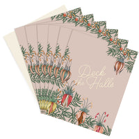 Stack of "Deck the Halls" holiday greeting cards with botanical illustrations featuring colorful flowers and green foliage. Illustrated by Lisel Ashlock.