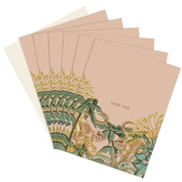 A fanned stack of pink greeting cards with botanical illustrations of yellow flowers and green leaves featuring monkeys, text reading "Love You" Illustrated by Lisel Ashlock.