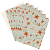 A fan of Happy Birthday greeting cards with orange flowers on sage green, illustrated by Lisel Ashlock.