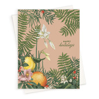 Holiday greeting card featuring blush background with illustrated citrus fruits, ferns, and white flowers surrounded by green foliage. Illustrated by Lisel Ashlock.