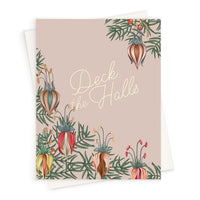 Greeting card with "Deck the Halls" text surrounded by illustrated botanical flowers in warm tones on beige background. Illustrated by Lisel Ashlock.
