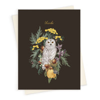 Thank you greeting card featuring a snowy owl surrounded by yellow flowers, fruits, and botanical elements on a dark background. Illustrated by Lisel Ashlock.