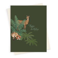 A forest-themed birthday greeting card featuring woodland animals and ferns on a green background. Illustrated by Lisel Ashlock.
