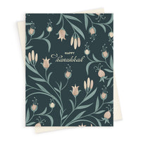 Happy Hanukkah greeting card with dark teal background and repeating botanical floral pattern in cream and sage. Illustrated by Lisel Ashlock.