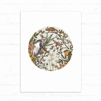 A circular illustration of a black and white guereza monkey surrounded by botanical elements including flowers, leaves, and small animals. Illustrated by Lisel Ashlock.