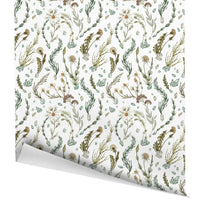 Botanical gift wrap featuring hand-drawn wildflowers, grasses, and herbs in muted greens and golds. Illustrated by Lisel Ashlock.