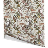 Guereza Garden gift wrap featuring illustrated monkeys, birds, fruits, and flowering plants in earth tones. Illustrated by Lisel Ashlock.