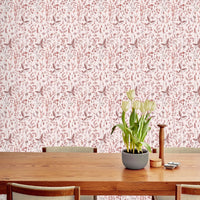 Sonoma Wallpaper in blush pink botanical pattern covering a wall above a wooden table with tulips. Illustrated by Lisel Ashlock.