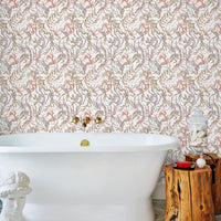 A luxurious bathroom featuring an ornate floral wallpaper in coral and taupe tones, a white freestanding bathtub, and wooden accents. Illustrated by Lisel Ashlock.