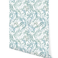 Rolled sample of Atoll wallpaper in marine featuring teal botanical sea life pattern on cream background, illustrated by Lisel Ashlock.