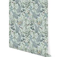 Rolled wallpaper featuring botanical garden pattern with birds and insects on robin egg blue background. Illustrated by Lisel Ashlock.