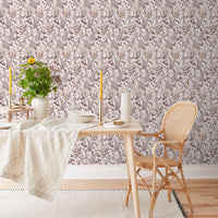 Secret Garden Wallpaper in blush adorns a dining space with wooden furniture and natural accents. Illustrated by Lisel Ashlock.