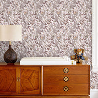 Secret Garden Wallpaper in blush tones featuring botanical ferns and foliage behind mid-century wooden furniture. Illustrated by Lisel Ashlock.