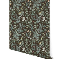 Rolled sample of Secret Garden Wallpaper in sable featuring botanical illustrations with birds and flowers. Illustrated by Lisel Ashlock.