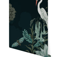 White heron perched among flowering plants and a butterfly on a dark background, wallpaper design. Illustrated by Lisel Ashlock.