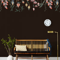 Mid-century wooden bench against dark wall with hanging floral mural wallpaper above. Illustrated by Lisel Ashlock.
