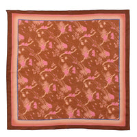 Silk cotton scarf with brown background featuring pink botanical motifs and fern patterns with layered borders. Illustrated by Lisel Ashlock.