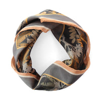 Silk cotton scarf in charcoal and copper with botanical leaf motifs and striped borders. Illustrated by Lisel Ashlock.