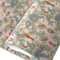 Holiday gift wrap featuring festive evergreen branches, berries, and ornamental flowers on a beige background. Illustrated by Lisel Ashlock.
