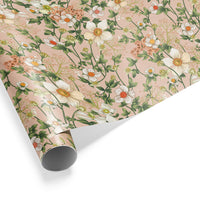 Rolled gift wrap featuring white anemones and peach flowers with green leaves on a pink background. Illustrated by Lisel Ashlock.
