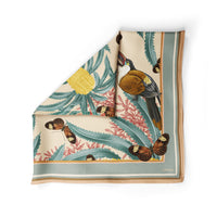 Silk cotton scarf featuring banksia flowers, birds, and butterflies in cream, teal, and gold. Illustrated by Lisel Ashlock.