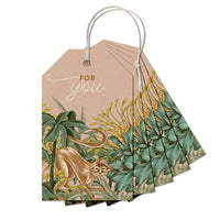 A fan of gift tags with botanical illustrations featuring a monkey in tropical foliage and "For you" text. Illustrated by Lisel Ashlock.