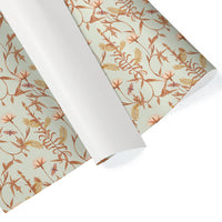 Rolls of flax-colored gift wrap featuring an illustrated botanical pattern of lily trees and leaves by Lisel Ashlock.