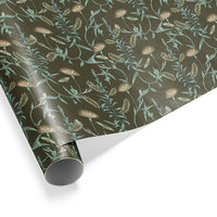 Rolled gift wrap featuring botanical pattern with orange lilies and green foliage on dark spruce background Illustrated by Lisel Ashlock