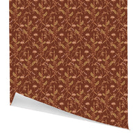 Rolled gift wrap with repeating botanical pattern of lily flowers and ferns on rust background. Illustrated by Lisel Ashlock.