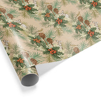 Rolled gift wrap featuring a beige background with repeating pattern of holly berries, pine branches, pinecones, and hares. Illustrated by Lisel Ashlock.