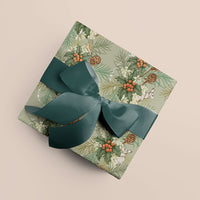 Wrapped gift with Holly & Hare mint green wrapping paper and teal ribbon bow on beige background. Illustrated by Lisel Ashlock.