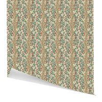 Rolled gift wrap featuring a festive pattern of green foliage, white flowers, and red berries on a blush background. Illustrated by Lisel Ashlock.