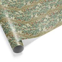 Rolled gift wrap featuring red berries, white flowers, and tan branches on sage green background. Illustrated by Lisel Ashlock.