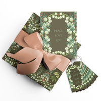 Snowbells gift tags and matching wrapping paper with sage green floral design and blush pink ribbon bow. Illustrated by Lisel Ashlock.