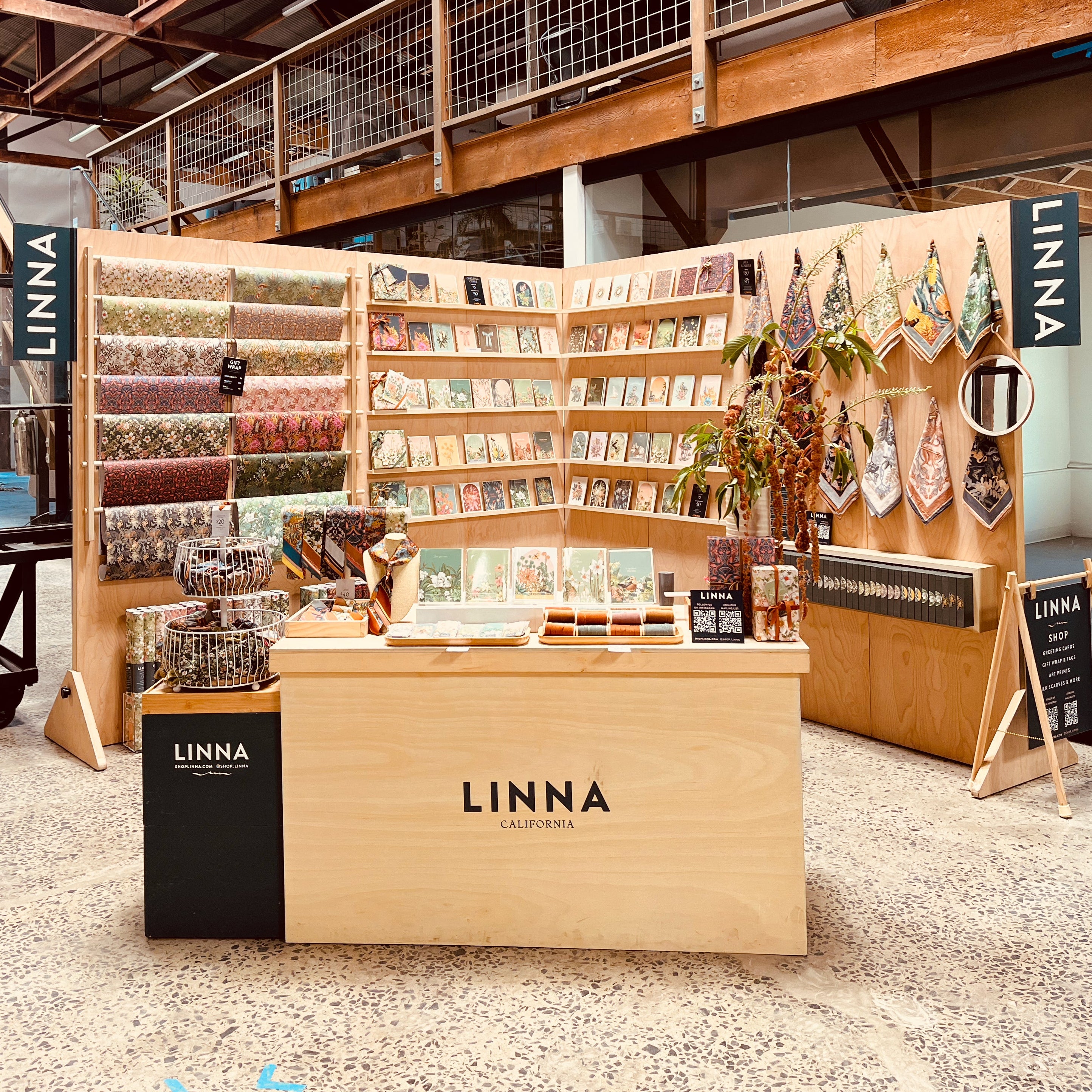 LINNA store interior with wooden display stands and products.