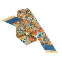 Marigold silk twilly scarf with vibrant floral pattern and striped ends, displayed flat. Illustrated by Lisel Ashlock.