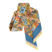Colorful silk twill scarf with floral pattern in orange, blue, and gold tones, illustrated by Lisel Ashlock.