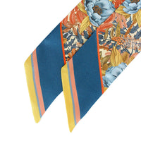 Marigold silk twilly scarf with blue, orange, yellow stripes and floral pattern. Illustrated by Lisel Ashlock.