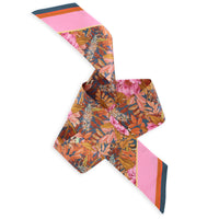 Colorful silk twilly scarf with peony flowers and striped details in pink, orange, and navy. Illustrated by Lisel Ashlock.