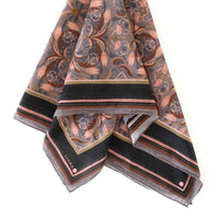 Folded silk cotton scarf with dusted lavender filigree floral pattern and black striped border. Illustrated by Lisel Ashlock.