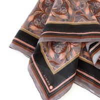 Folded silk cotton scarf in dusted lavender with filigree floral pattern and striped border, illustrated by Lisel Ashlock.